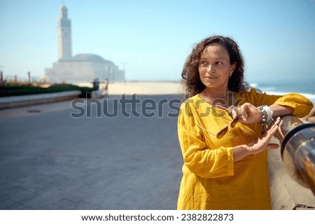 Similar – Image, Stock Photo A woman iis looking at her smartphone outdoors.