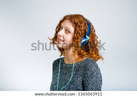 Young blonde woman listening to music with her headphones