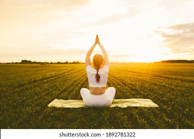 Beautiful Curvy Girl With Red Hair Doing Yoga In Nature On A Sunny Summer Sunset. Body Positive, Sports For Women, Harmony, Asana, Healthy Lifestyle, Inspiring Look, Self-love And Wellness.