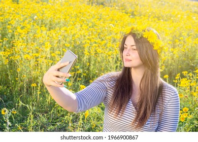 beautiful curvy woman poses outdoors with  daisy crown. take selfie in a meadow with daisies - Powered by Shutterstock