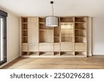 Beautiful custom made oak bookcase with display cabinet, drawers, drawers and shelves in an apartment with wooden flooring