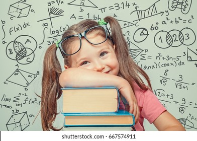 Beautiful Cute Little Genius Girl With Books And Math Formulas, Problems Around Her