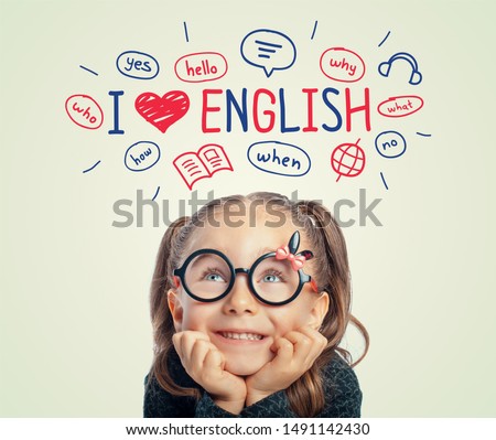 Beautiful cute little girl with eyeglasses looking at i love english word, illustrations and words above her head.  i love english concept.