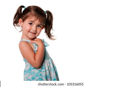 Beautiful Cute Toddler Girl With Pigtails Pointing At Herself In Blue Summer Dress, Isolated. Who, Me Expression.