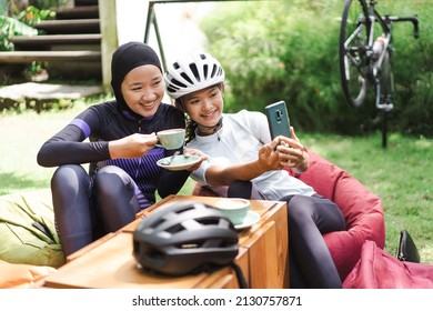 beautiful cyclist take a break at coffee shop and taking photos together - Powered by Shutterstock