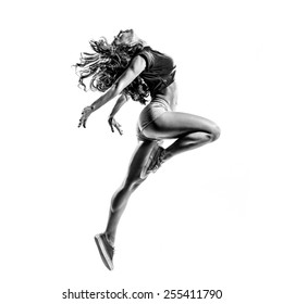 Beautiful Dancer Jumping On A White Isolated Background In Black And White Color. High Contrast Black And White Image