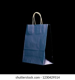 Beautiful Dark Blue Gift Bag. Close Up. Isolated On Black Background.