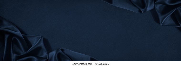 Beautiful dark blue silk satin background. Soft folds on shiny fabric. Luxury background with copy space for text, design. Web banner. Flat lay, top view table.Birthday, Christmas, Valentine's Day. - Shutterstock ID 2019336026