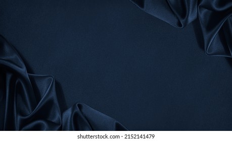 Beautiful dark blue silk satin background. Soft folds on shiny fabric. Luxury background with space for design. Web banner. Flat lay, Table top view. Christmas, Valentine's Day. - Shutterstock ID 2152141479