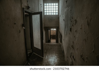 A Beautiful Dark Corridor With Windows And Doors. An Old Abandoned House. Light In The Windows. Dim Corridor. Shabby Walls. Scary Atmosphere Of An Abandoned Building.