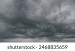 Beautiful dark dramatic sky with stormy clouds before rain or snow. Thunderstorm heaven landscape. Timelapse.