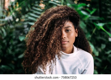Beautiful dark skinned girl with curly hair.