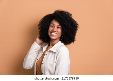 Beautiful Dark Skinned Woman Touching Hair Wearing White Jacket In Studio Shot. Portrait, Real People Concept.