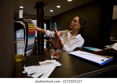 Beautiful Dark-haired Caucasian Woman Freelance Designer Photographing Colorful Fabric Samples While Planning New Home Design Project In A Home Design Showroom