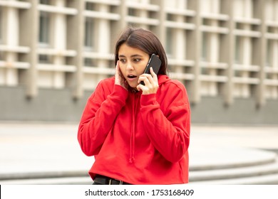 Beautiful Dark-skinned Woman In Red Speaks On The Phone Can Not Believe What She Heard