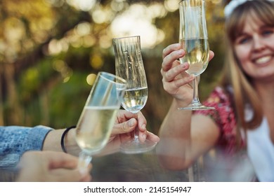 Its A Beautiful Day To Celebrate And Have Champagne. Cropped Shot Of Unrecognizable Women Toasting With Champagne At A Tea Party Outside.