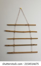 Beautiful Decor Element Made Of Dry Bamboo Sticks Hanging On White Wall