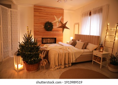 Beautiful Decorated Christmas Tree With Fairy Lights In Bedroom Interior