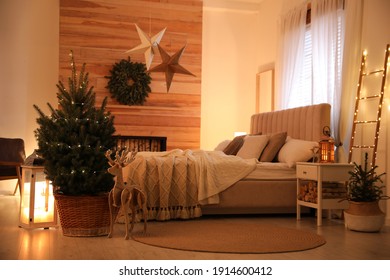 Beautiful Decorated Christmas Tree With Fairy Lights In Bedroom Interior