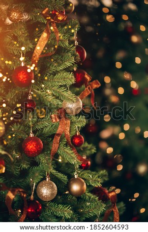 Beautiful and decorated Christmas tree in the mirror reflection. Christmas mood. Great photo for greeting cards.