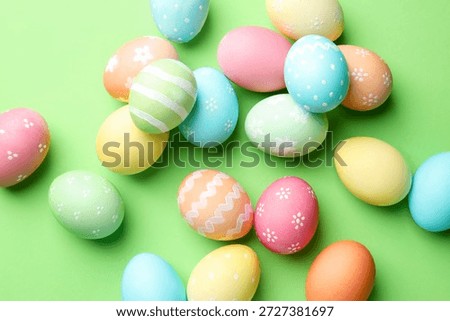 Beautiful decorated Easter eggs on green background, flat lay