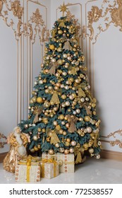 Beautiful Decorated Golden Christmas Tree With Present Boxes In Luxury Classic Interior