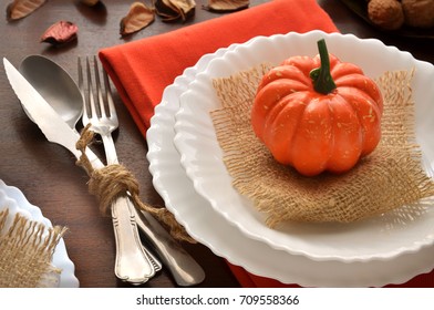 Beautiful Decoration For Autumn Table Scape And Settings: White Plate, Decorative Pumpkin And Orange Linen Napkin With Cutlery. Fall Harvest Concept. Thanksgiving Day Festive Background. 