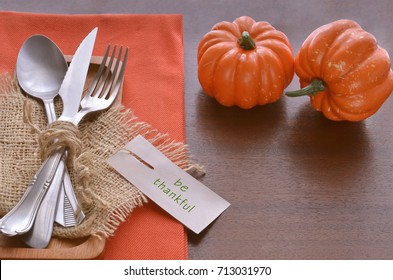 Beautiful Decoration For Autumn Table Scape And Settings: White Plate, Decorative Pumpkin And Orange Linen Napkin With Cutlery. Fall Harvest Concept. Thanksgiving Day Festive Background 