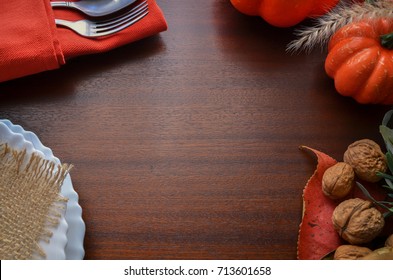 Beautiful Decoration For Autumn Table Scape And Settings: White Plate, Decorative Pumpkin And Orange Linen Napkin With Cutlery. Fall Harvest Concept. Thanksgiving Day Festive Background 