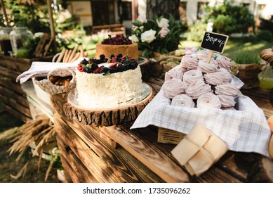 A Beautiful Decoration Of The Wedding Buffet Table Outdoors With Sweets, Fresh Flowers On Wooden Coasters,an Abundance Of Sweets On Wooden Coasters.,buffet Reception In Nature.