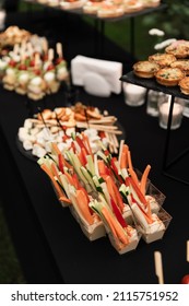 A Beautiful Decoration Of The Wedding Buffet Table Outdoors With Sweets, Fresh Flowers On Wooden Coasters,an Abundance Of Sweets On Wooden Coasters.,buffet Reception In Nature.