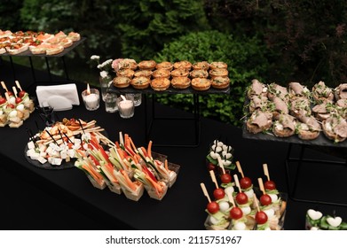 A Beautiful Decoration Of The Wedding Buffet Table Outdoors With Sweets, Fresh Flowers On Wooden Coasters,an Abundance Of Sweets On Wooden Coasters.,buffet Reception In Nature.