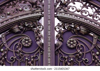 Beautiful decorative elements of wrought iron gates in purple