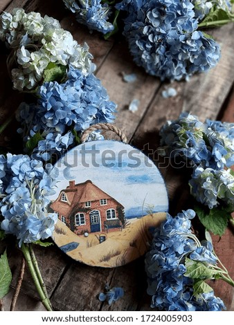 Beautiful decoupage craft and blue hydrangea flowers on rustic wooden table. Selective focus. Blurry background.