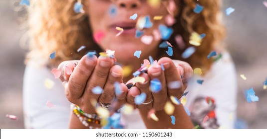 beautiful defocused woman blow confetti from hands. celebration and event concept. happiness and coloured image. movement and happiness having fun - Shutterstock ID 1150601243