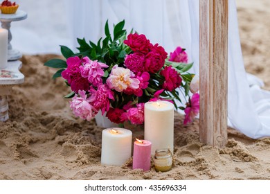 Beautiful, Delicate Wedding Decorations With Candles And Fresh Flowers On The Beach