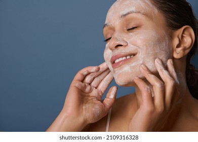 Beautiful Delighted Woman With Perfectly Healthy Skin, Holding Hands On Her Face, Performing Smoothing Massage, Removing Makeup And Cleansing Face With Exfoliating Scrub And Facial Foam Cleanser.