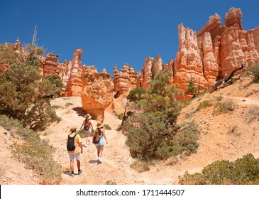 Beautiful Desert Scenery. Family Exploring Utah On Summer Vacation. People With Backpacks Hiking In The Desert. Bryce Canyon National Park, Utah, USA. 