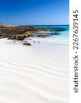 beautiful deserted rocky beach with pure white sand and turquoise water 