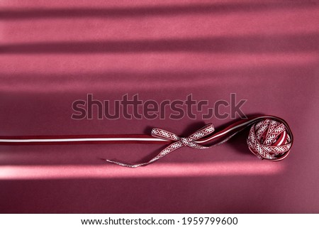 Beautiful design, decoration with latvian national symbols  Lielvarde belt and Latvia flag ribbon for independence day celebration posters or templates on a dark red background