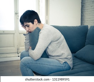 Beautiful desperate and depressed young woman on sofa feeling sad, hopeless and in pain suffering from Depression in People, Mental health,broken heart, Grief and Psychology concept.
