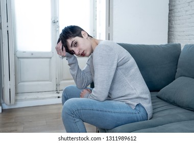 Beautiful desperate and depressed young woman on sofa feeling sad, hopeless and in pain suffering from Depression in People, Mental health,broken heart, Grief and Psychology concept.