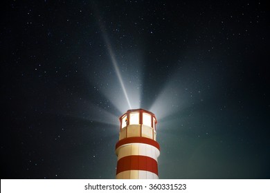 Beautiful Detail Of White And Red Lighthouse With Shining Light And Stars