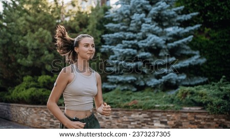 Beautiful diabetic woman running in the city. Young woman wearing insulin pump during exercising. Concept of exercise and diabetes.