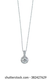 A Beautiful Diamond Halo And White Gold Pendant Dangles From A Chain. Fine Jewelry Necklace Isolated On A White Background With Shadow And Reflection