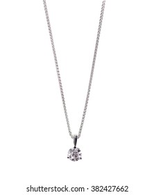 A Beautiful Diamond And White Gold Pendant Dangles From A Chain. Fine Jewelry Necklace Isolated On A White Background With Shadow And Reflection