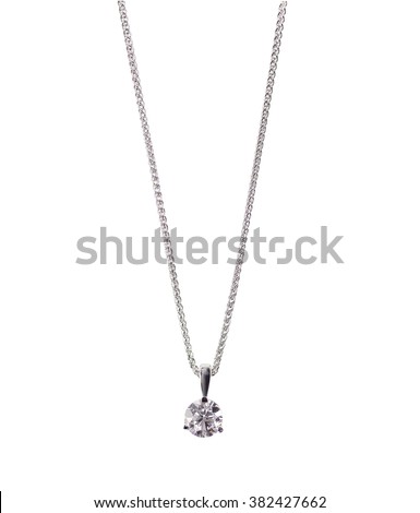 A beautiful diamond and white gold pendant dangles from a chain. Fine Jewelry necklace isolated on a white background with shadow and reflection