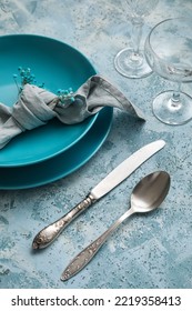 Beautiful Dinnerware And Gypsophila Flowers On Blue Table, Closeup