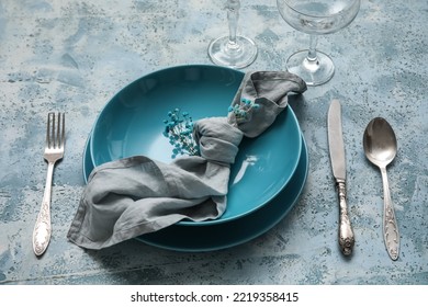 Beautiful Dinnerware And Gypsophila Flowers On Blue Table