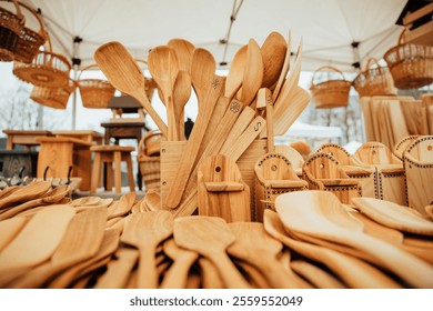 A beautiful display of handmade wooden spoons, spatulas, and utensils at a craft market, showcasing sustainable kitchen tools crafted from natural wood. Perfect for rustic or eco-friendly kitchens - Powered by Shutterstock